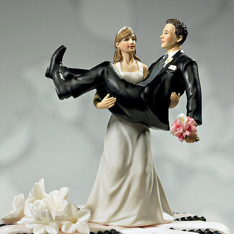 Bride holding Groom Wedding Cake Topper